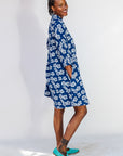 Model wearing blue and white floral dress.