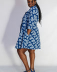 Model wearing blue and white floral dress.