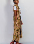 Model wearing beige, yellow and black geometric print dress.