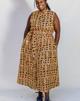 Model wearing beige, yellow and black geometric print dress.