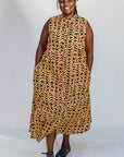 Model wearing beige, yellow and black geometric print dress.