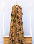 Display of beige, yellow and black geometric print dress.