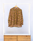 Display of beige, yellow and black geometric print shirt.
