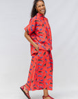 Model wearing red cat print shirt and culotte.