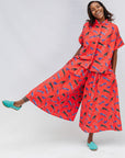 Model wearing red cat print shirt and culotte.