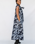 Model wearing navy and gray abstract print maxi dress.