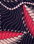 Close up display of navy blue dress with black, pink and baby pink chrysalis