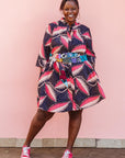 The model is wearing navy blue dress with black, pink and baby pink chrysalis