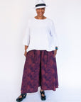 Model wearing navy pants with pink dots.