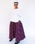 Model wearing navy pants with pink dots.