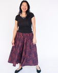 Model wearing navy pants with pink dots.