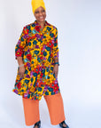 Model wearing yellow dress with multicolor floral print.