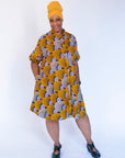 Model wearing orange and purple dress.