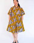 Model wearing orange and purple dress.