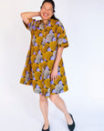 Model wearing orange and purple dress.