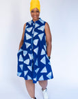 Model wearing blue sleeveless dress with white triangle print.