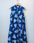 Display of blue sleeveless dress with white triangle print.