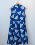 Display of blue sleeveless dress with white triangle print.