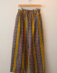 Display of yellow pants with blue zig zag pattern.