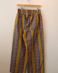 Display of yellow pants with blue zig zag pattern.