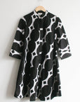Display of black and white geometric print dress.