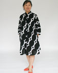 Model wearing black and white geometric print dress.