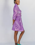 Model wearing purple and pink plaid batik dress.