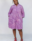 Model wearing purple and pink plaid batik dress.