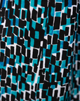 Close up display of blue, black and white abstract print sleeveless shirt, fabric.