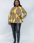 Model wearing yellow, brown and white abstract print shirt.
