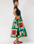 Model wearing multicolored geometric print skirt.