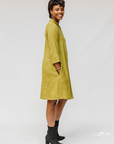 Model wearing olive green linen dress.