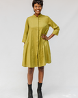 Model wearing olive green linen dress.