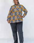 Model wearing of blue, white and yellow abstract print shirt.