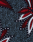 Close up display of grey, red and black dragonfly print dress, fabric.