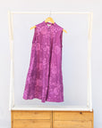 Display of purple dress with pink beet print.