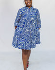 Model wearing blue and white zigzag print dress.
