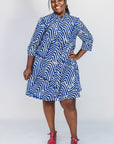 Model wearing blue and white zigzag print dress.
