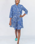 Model wearing blue and white zigzag print dress.