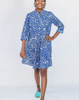 Model wearing blue and white zigzag print dress.