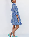 Model wearing blue and white zigzag print dress.