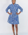 Model wearing blue and white zigzag print dress.