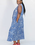 Model wearing blue and white sleeveless dress.