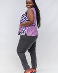 Model wearing purple, pink and white geometric print, patchwork sleeveless shirt.