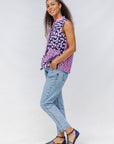 Model wearing purple, pink and white geometric print, patchwork sleeveless shirt.