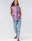 Model wearing purple, pink and white geometric print, patchwork sleeveless shirt.