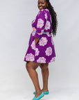 Model wearing purple and white floral print dress.