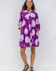 Model wearing purple and white floral print dress.