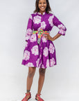 Model wearing purple and white floral print dress.
