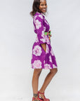 Model wearing purple and white floral print dress.